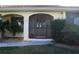 Close up of the front entryway showing the screen door, stonework, and well maintained plants at 3448 Nighthawk Ct, Punta Gorda, FL 33950