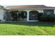 Charming home entrance featuring a tiled roof, screened entry, and well-maintained landscaping at 3448 Nighthawk Ct, Punta Gorda, FL 33950