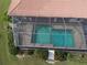 Aerial view of screened in pool and patio area nestled among mature trees at 3448 Nighthawk Ct, Punta Gorda, FL 33950