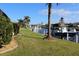 Scenic view of a waterfront canal with private docks, boats, and lush green lawns at 3448 Nighthawk Ct, Punta Gorda, FL 33950