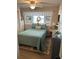 Cozy bedroom with a comfortable bed, built-in shelves, and light flooring at 6603 Hauli Ct, North Port, FL 34287