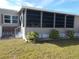 Home exterior with landscaping and screened porch at 6603 Hauli Ct, North Port, FL 34287