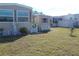 Home exterior with shed and a white gate at 6603 Hauli Ct, North Port, FL 34287