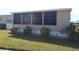Home exterior with landscaping and screened porch at 6603 Hauli Ct, North Port, FL 34287