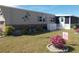 Tan home exterior with landscaping and a dragonfly decoration at 6603 Hauli Ct, North Port, FL 34287