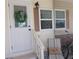 Front door entrance with wreath, porch seating, and bikes at 6603 Hauli Ct, North Port, FL 34287