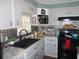 Galley kitchen with stainless steel appliances and granite countertops at 6603 Hauli Ct, North Port, FL 34287