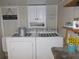 Bright laundry room with washer, dryer, and ample storage at 6603 Hauli Ct, North Port, FL 34287