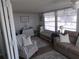 Bright living room with comfy seating and large windows at 6603 Hauli Ct, North Port, FL 34287