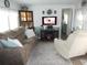 Relaxing living room, featuring a plush sofa and recliner at 6603 Hauli Ct, North Port, FL 34287