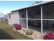 Screened porch with table, chairs, and plants at 6603 Hauli Ct, North Port, FL 34287