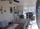 Screened-in sunroom with outdoor furniture and partial view at 6603 Hauli Ct, North Port, FL 34287