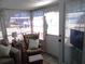 Relaxing sunroom boasts ample natural light and comfy seating at 6603 Hauli Ct, North Port, FL 34287
