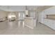 Open concept kitchen with white cabinets and tile floors at 7146 Sablon Rd, North Port, FL 34291