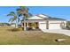 Single-story home with two-car garage and landscaped yard at 25228 Nocturne Ln, Punta Gorda, FL 33983