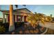 Welcoming front entrance with vibrant landscaping, red shutters, and a well-maintained yard at 25228 Nocturne Ln, Punta Gorda, FL 33983