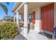 Welcoming front porch with seating invites relaxation and adds curb appeal to the home at 25228 Nocturne Ln, Punta Gorda, FL 33983