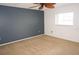 Bedroom with a neutral carpet, ceiling fan, and a stylish dark accent wall at 3310 Loveland Blvd # 1408, Port Charlotte, FL 33980