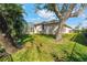 Landscaped backyard with lush lawn and large tree at 219 White Marsh Ln, Rotonda West, FL 33947