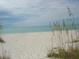 Scenic beach view with white sand and calm ocean at 219 White Marsh Ln, Rotonda West, FL 33947