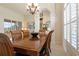 Elegant dining room with a large wood table and chandelier at 219 White Marsh Ln, Rotonda West, FL 33947