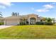 One-story home with attached garage, and nicely landscaped lawn at 219 White Marsh Ln, Rotonda West, FL 33947