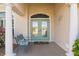 Inviting front entry with double doors and a charming bench at 219 White Marsh Ln, Rotonda West, FL 33947