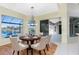 Elegant dining room with a large table and access to a pool view at 3911 Crooked Island Dr, Punta Gorda, FL 33950