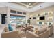 Bright living room featuring a unique built-in shelving unit and water views at 3911 Crooked Island Dr, Punta Gorda, FL 33950