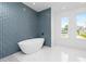 Bathroom with freestanding tub and blue tile at 425 Orinoco St, Punta Gorda, FL 33983