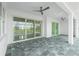 Spacious covered patio with multiple sliding glass doors and two ceiling fans at 425 Orinoco St, Punta Gorda, FL 33983