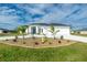 Modern two-story home with white exterior, two-car garage, and lush landscaping at 425 Orinoco St, Punta Gorda, FL 33983