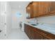 Bright laundry room with wood cabinets, marble countertop, and a sink at 425 Orinoco St, Punta Gorda, FL 33983