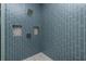 Modern shower with blue tile, built-in shelves, and rainfall shower head at 425 Orinoco St, Punta Gorda, FL 33983