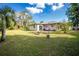 Large backyard showing back of the house, brick paved patio and fire pit at 1190 Victoria Ave Nw, Port Charlotte, FL 33948