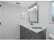 Bathroom showcases a gray vanity with granite countertop and modern lighting at 1190 Victoria Ave Nw, Port Charlotte, FL 33948