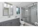 Bathroom featuring a gray vanity and tiled walk-in shower with a bench at 1190 Victoria Ave Nw, Port Charlotte, FL 33948