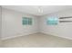 Bedroom featuring two windows, tile flooring, and a chandelier at 1190 Victoria Ave Nw, Port Charlotte, FL 33948