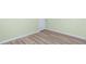 Bedroom showcases wood-look flooring with a white door and neutral walls at 1190 Victoria Ave Nw, Port Charlotte, FL 33948