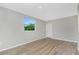 Cozy bedroom with a large window and light-colored walls and flooring at 1190 Victoria Ave Nw, Port Charlotte, FL 33948
