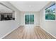 Dining room with wood-look flooring and sliding glass door at 1190 Victoria Ave Nw, Port Charlotte, FL 33948