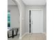 Entryway featuring tile flooring and a glass table by an arched entry to the living room at 1190 Victoria Ave Nw, Port Charlotte, FL 33948