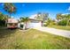 Exterior of home with garage door and palm trees at 1190 Victoria Ave Nw, Port Charlotte, FL 33948