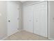 Hallway featuring a door and a double-door closet for storage at 1190 Victoria Ave Nw, Port Charlotte, FL 33948