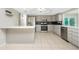 Updated kitchen featuring gray cabinets, stainless steel appliances, and tile flooring at 1190 Victoria Ave Nw, Port Charlotte, FL 33948