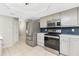 Modern kitchen featuring stainless steel appliances and tile flooring at 1190 Victoria Ave Nw, Port Charlotte, FL 33948