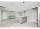 Kitchen with center island, tile flooring, coffee bar, and neutral paint at 1190 Victoria Ave Nw, Port Charlotte, FL 33948
