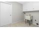 Laundry room featuring a utility sink and white cabinetry at 1190 Victoria Ave Nw, Port Charlotte, FL 33948