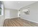 Open living room with pass-through to the kitchen and light wood-look flooring at 1190 Victoria Ave Nw, Port Charlotte, FL 33948