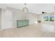 Open-concept living room with tile flooring, vintage hutch, and ceiling fan at 1190 Victoria Ave Nw, Port Charlotte, FL 33948